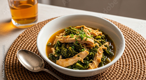 Healthy Chicken Kale Soup In White Bowl On Placemat