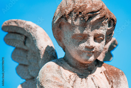 Billede på lærred Guardian angel child statue against bright blue sky.