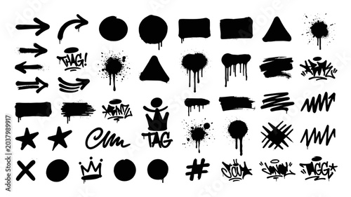 Set of black grunge graffiti spray paint tags arrows splatters and rough shapes on white background on transparent background