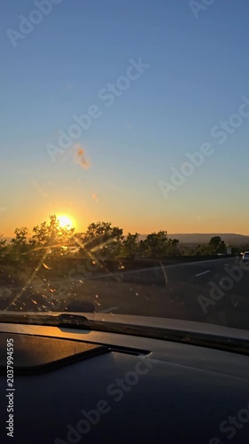 Sunset view from moving car on highway