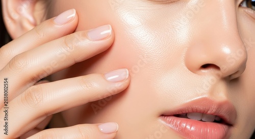Close up of radiant skin and gentle hand placement, showcasing a dewy complexion and natural youthful glow with a soft aesthetic finish, spa, bright, gentle