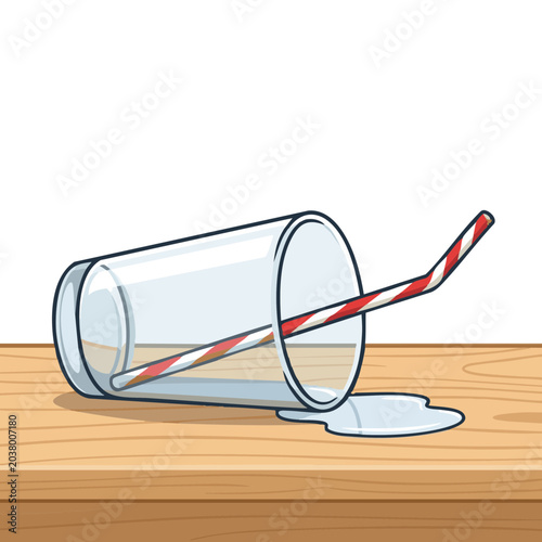 Tipped glass with straw spilling liquid on wooden table  
