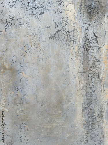 Intricate web of age-worn fissures across a weathered concrete surface revealing textured decay