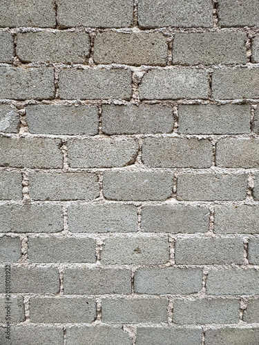 Rough hewn concrete block structure offering robust textural patterns and foundational stability