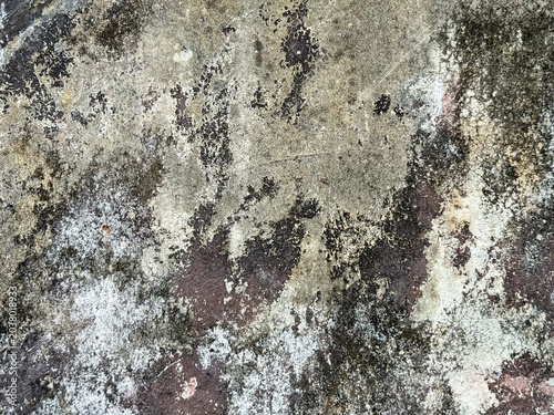 Rough urban plaster showing variegated streaks of environmental wear and subtle chromatic shifts