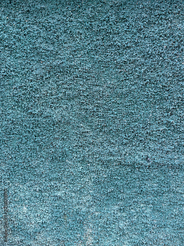 Subtle aquatic blue wall surface with a granular texture reflecting a calming architectural finish
