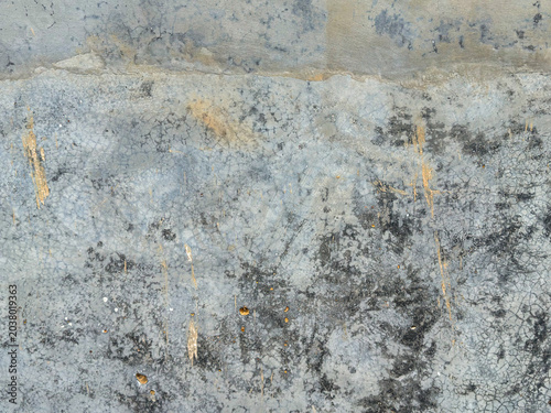 Textural interplay of worn concrete with deep grey mottling and vertical streaks of warm, rustic