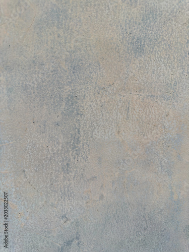 Subtle patinas on a weathered surface displaying an interplay of muted cool tones