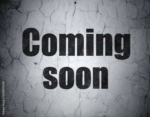 Coming soon text on cracked concrete wall