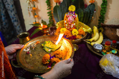 Obraz na plátně woman performing aarti offerings on brass plate during hindu puja ritual