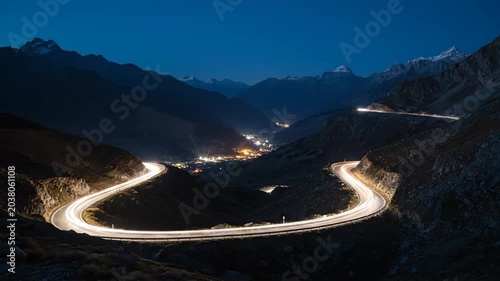 Winding road through mountains at night.