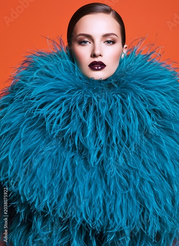High Fashion Beautiful Woman Portrait Wearing Extravagant Turquoise Blue Feather Collar Coat Accessory