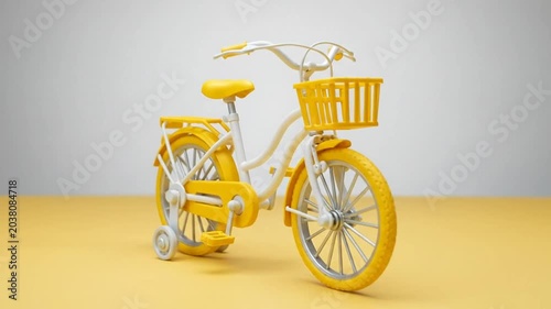 Minimalist yellow bicycle with training wheels and front basket on yellow and white background.