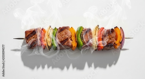 Grilled meat and vegetable shish kebab on a skewer.