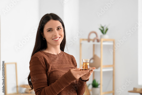 Young woman with Turkish tea at home