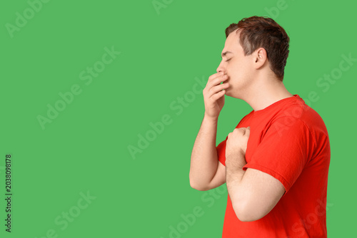 Young man with sore throat ...