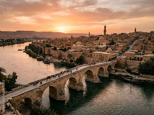 Ancient bridge over the Euphrates River near historic architecture