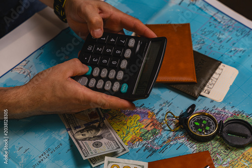Budgeting for travel expenses using a calculator on a world map