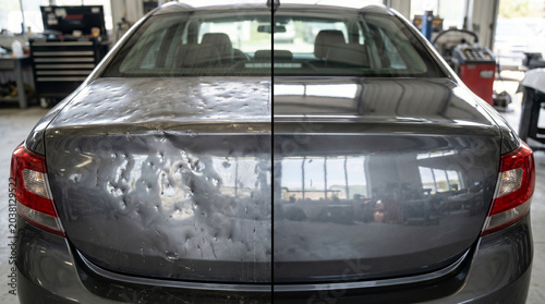 Damaged and repaired car trunk in automotive service center