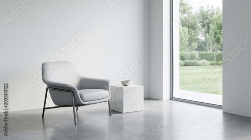 Modern grey armchair and marble cube in white room. Minimalist interior with armchair and garden view through large window