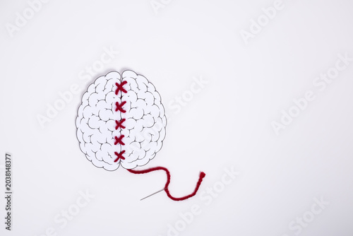 Schilderij op canvas Conceptual brain illustration repaired with red stitching thread