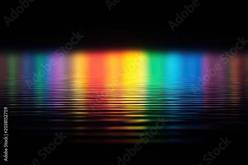 Vibrant abstract reflection of colorful lights on calm water surface.