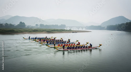 Dragon boat teams racing on a calm river during a traditional festival.