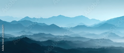 Blue-toned layered mountains shrouded in atmospheric haze