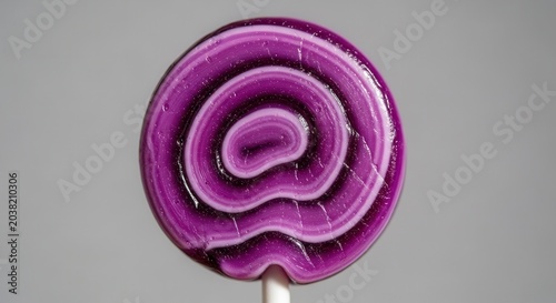 Purple spiral design on pin back.