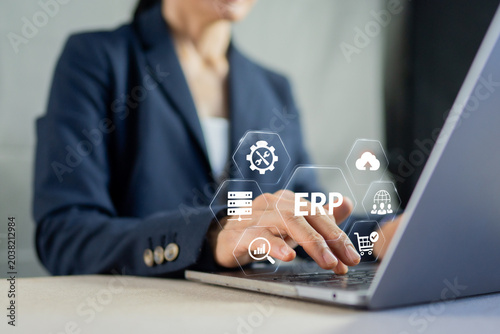 Photos Businesswoman using laptop with ERP Enterprise Resource Planning software integr