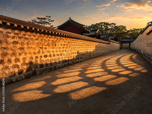 Traditional Korean Palace Lane with Geometric Sunset Shadows