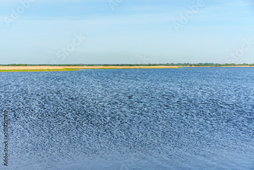 Scenic view of Lake Liepaja with reeds under blue sky, Latvia