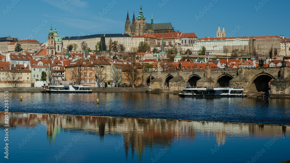 Fototapeta premium Experience the enchanting skyline of Prague featuring its iconic landmarks by the Vltava River. The historic architecture and serene waters create a perfect setting for travel and exploration.
