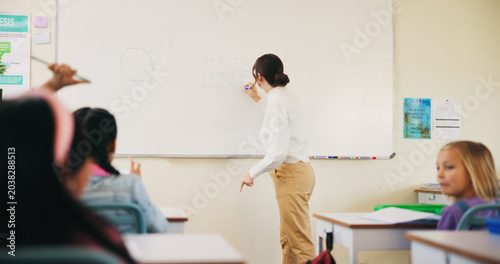 Obraz na plátně Students, teacher or woman with writing on whiteboard, addition lesson or math syllabus for learning