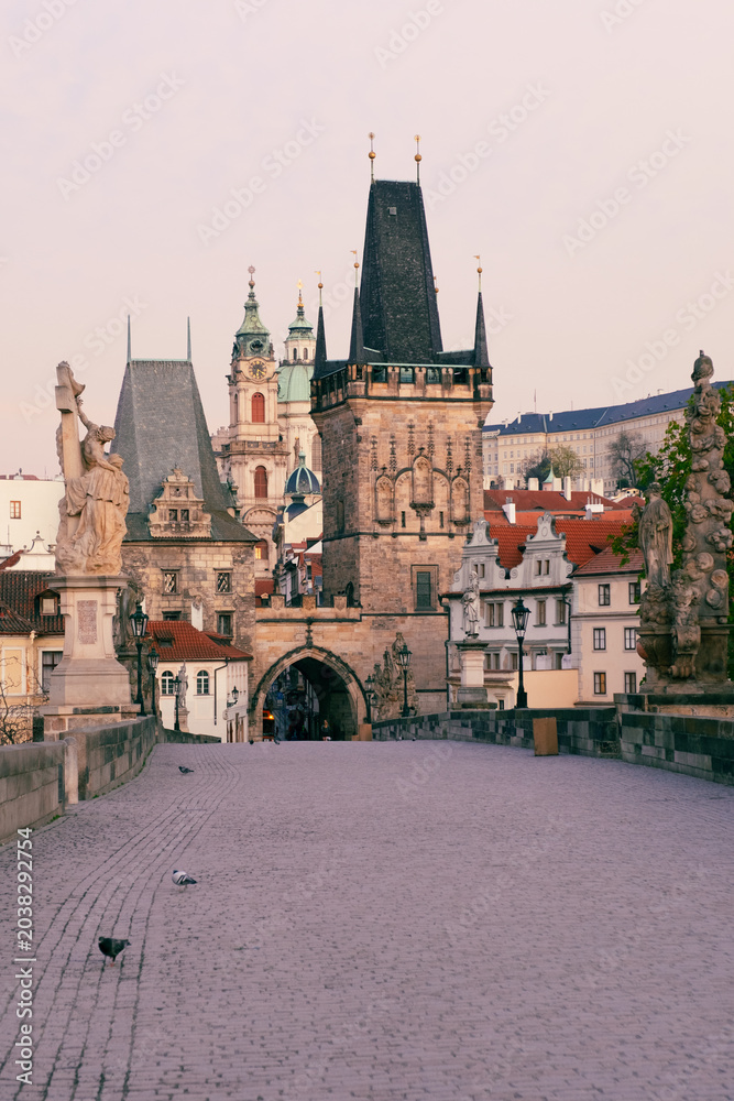 Fototapeta premium empty Charles Bridge in Prague, Czechia, admiring the gothic towers and statues.