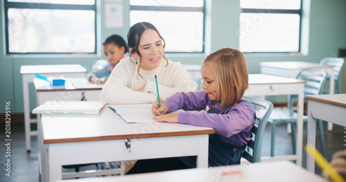 фотографія Teacher, students or girl with help in classroom, task assistance or advice for academic development