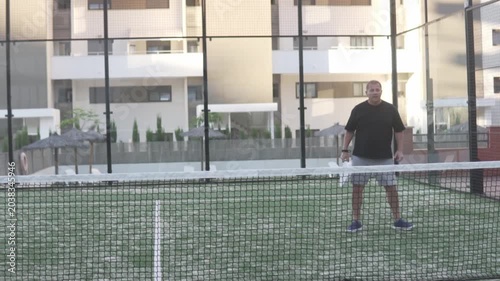 Concept Padel Tennis Training, Focus on Nets, Man Hitting Balls With Racket