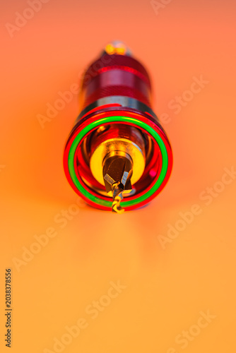 Engineering Series : Close up of a pilot drill with countersink bit set in a quick release holder under vibrant RGB lighting.