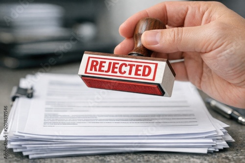 A rejection stamp with the word 'rejected' printed on it