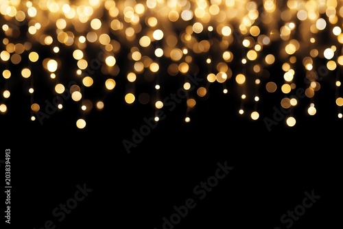 Golden bokeh lights creating a festive atmosphere against a dark background.