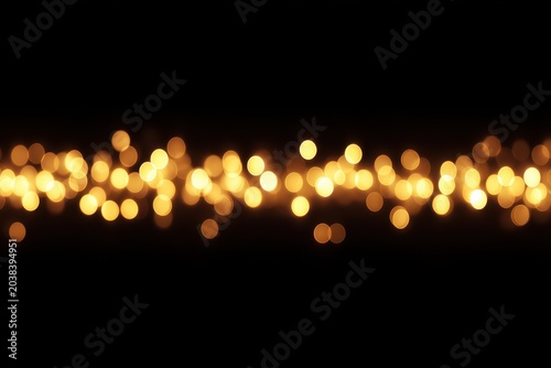 A mesmerizing blur of warm golden bokeh against a dark background.