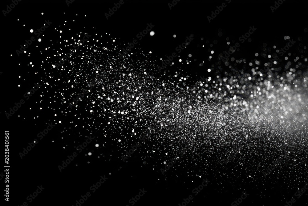 Fototapeta premium A mesmerizing spray of white particles against a stark black background.