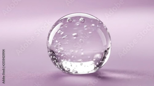 Macro Shot of Clear Cosmetic Gel Droplet with Air Bubbles on Pastel Background