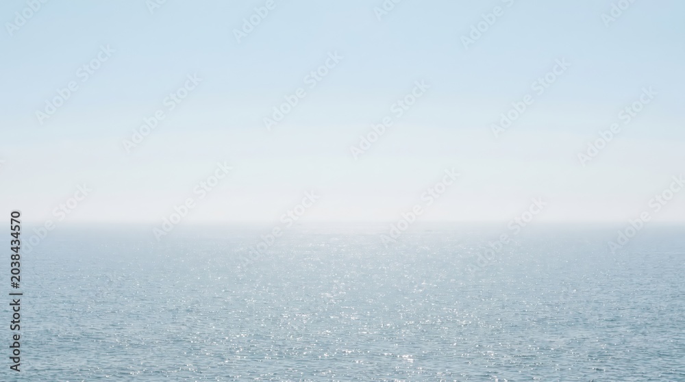 Fototapeta premium Ocean water background with calm blue sea surface and sun light reflection