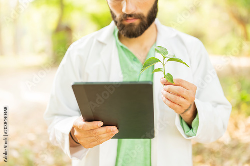 Ecologist looking at the plant during a heat wave