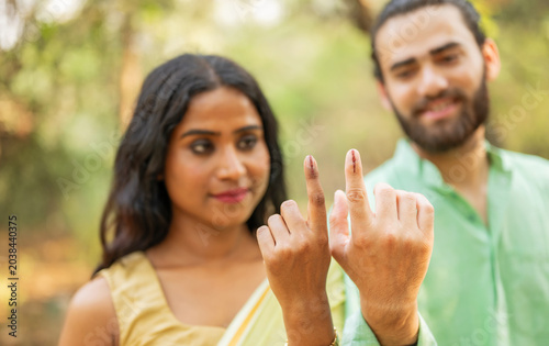 Indian man and woman showing elections mark on the finger