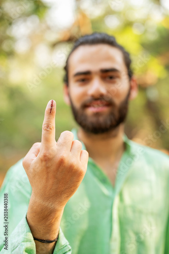 Indian man showing elections mark on the finger