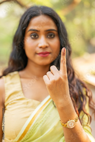Serious Indian woman showing elections mark on the finger