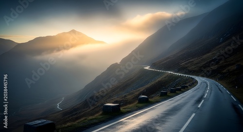 Winding road through misty mountain landscape.
