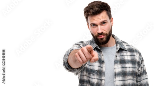 A person pointing straight ahead at the viewer with a serious expression. Isolated on white background.